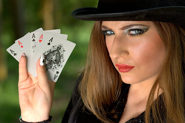 woman holding five Ace cards