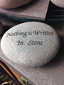 gray stone with Nothing is Written in Stone text