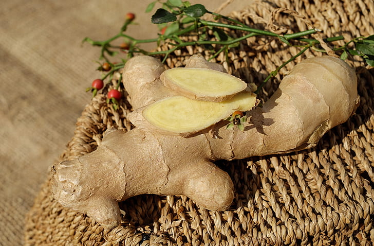 closeup photo of ginger on brown woven surface
