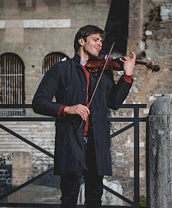 man playing brown violin with bow
