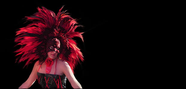woman wearing a red headdress in a dark area