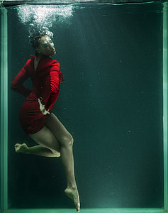 woman wearing red long-sleeved mini dress in water