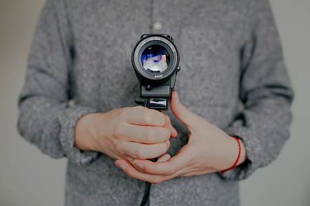 man holding black video camera