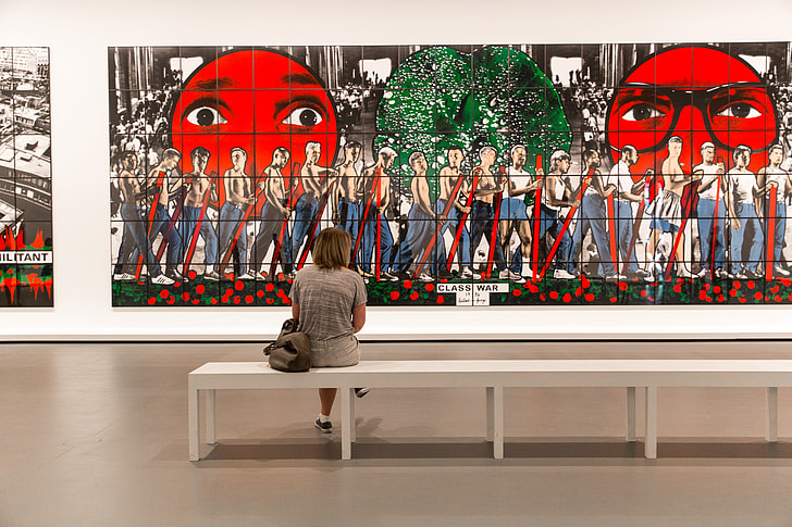A woman sits in a modern art gallery in Paris, France