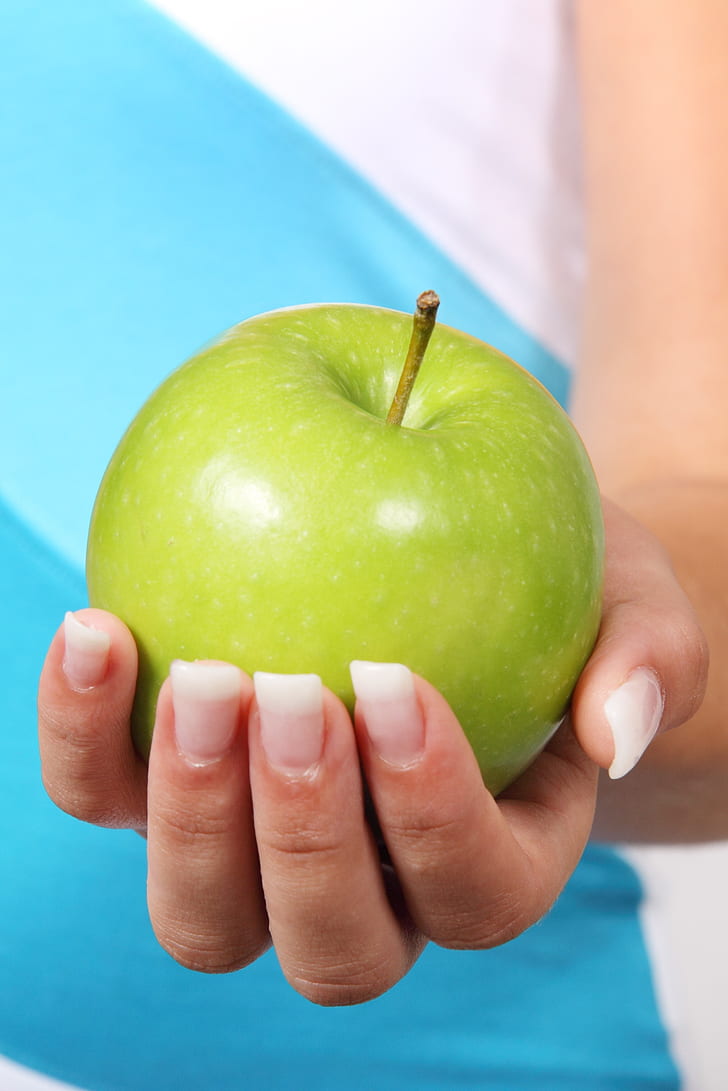 granny smith on person's hand