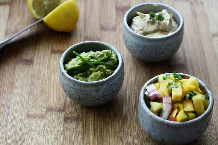 three grey ceramic bowls with fruits