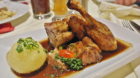 serving of roasted chicken on white ceramic dinner plate