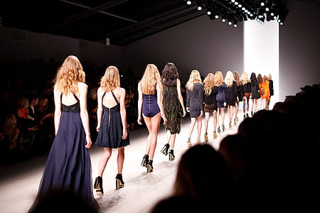 female fashion models walking towards white lit room