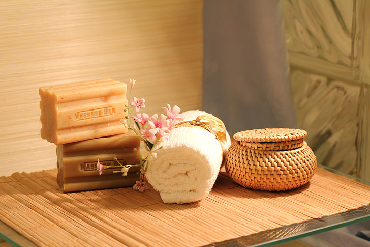 two massage soap bars beside white towel on table