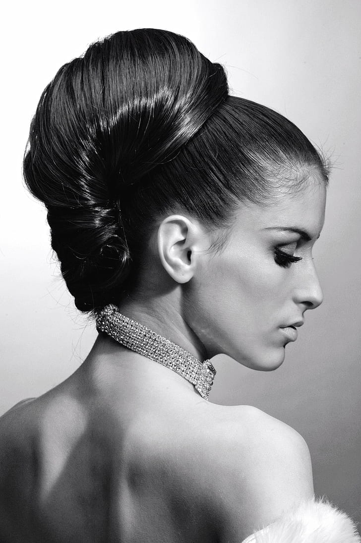 grayscale portrait photography of woman with bun hair