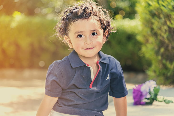 selective photo of toddler's in gray polo shirt