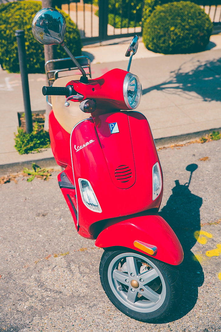 red and gray motor scooter