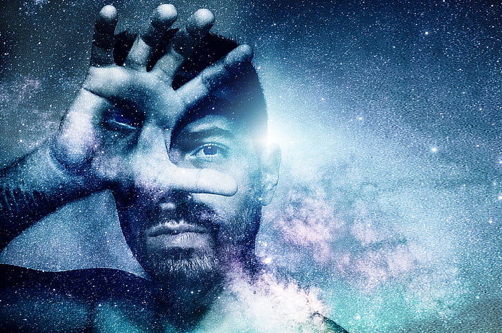 man covering right eye with nebula effects