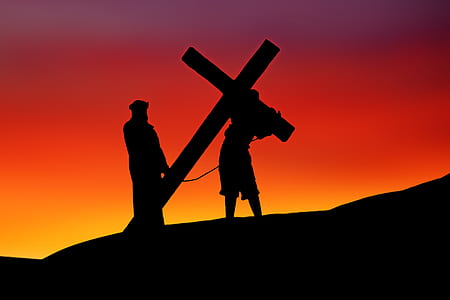 silhouette photo of Jesus Christ image holding cross