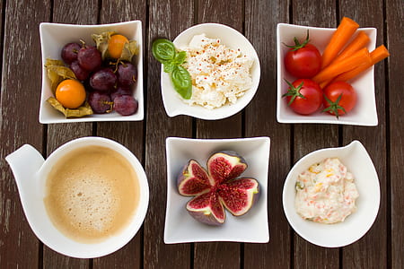 six white ceramic bowls filled with assorted dishes