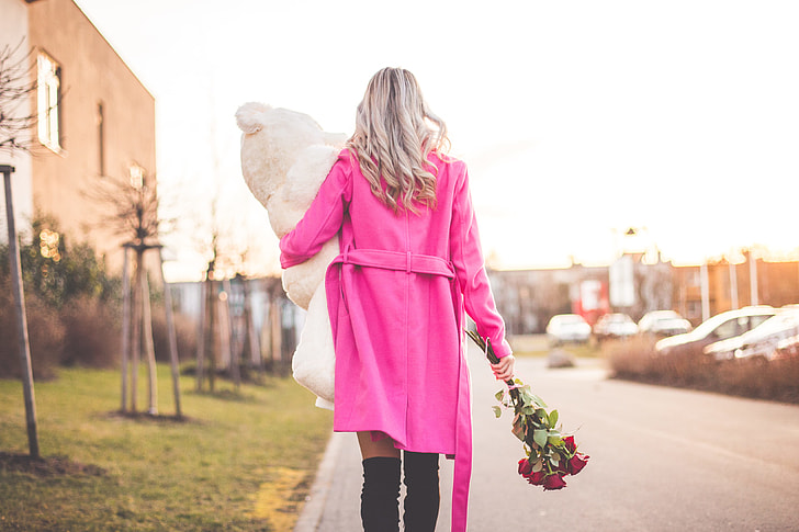 Woman with Big Teddy and Roses Walking on the Street