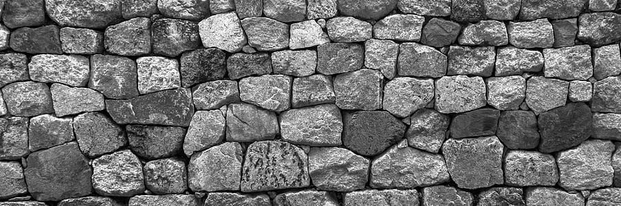 greyscale photo of bricks
