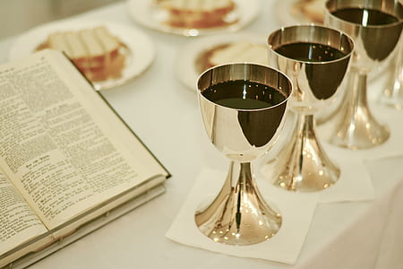 three gold goblets with wines