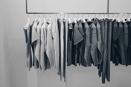 grayscale photo of organized cloth lot