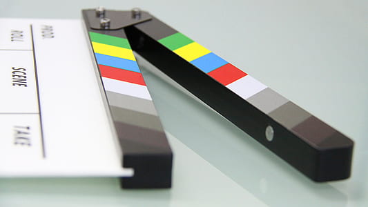 white and black clapperboard on white glass surface