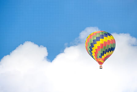 Yellow Blue and Green Hot Air Balloon Flying Near White Clouds