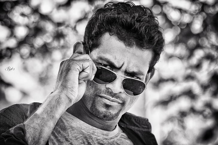grayscale photography of man in aviator sunglasses