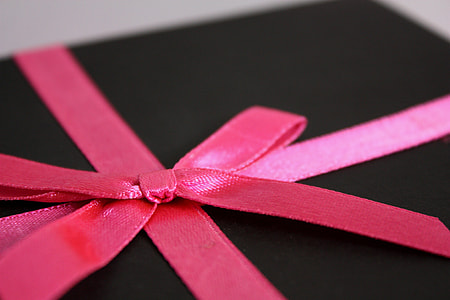 black box with pink bow cord
