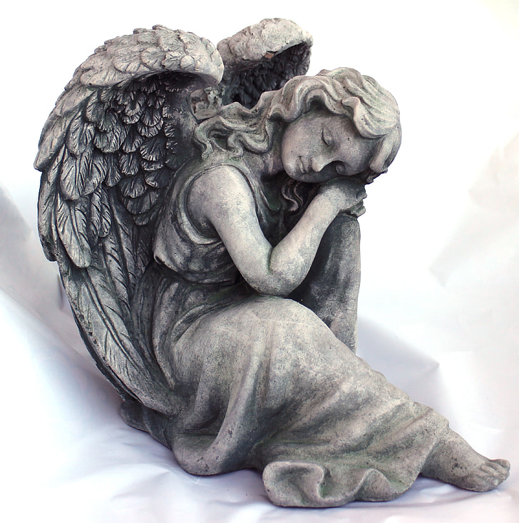 gray concrete figure of an angel sleeping