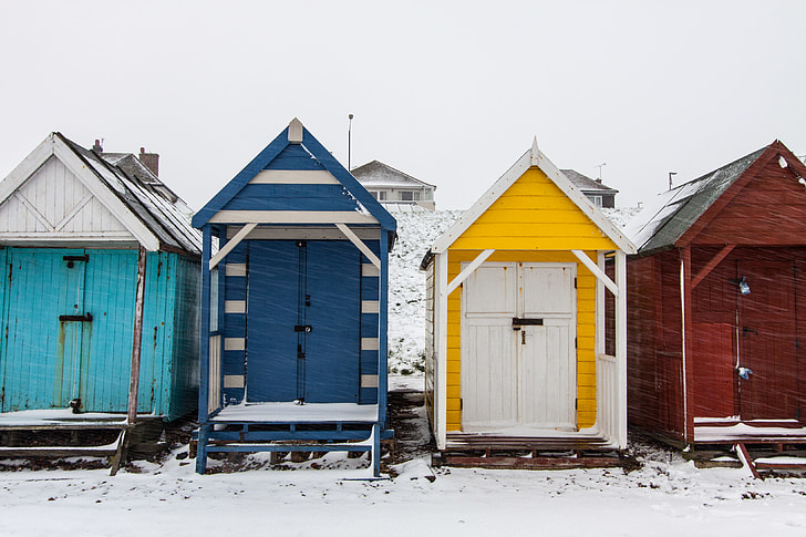 Winter-time scene of snow covered beach huts on the Kent Coast in Southern England