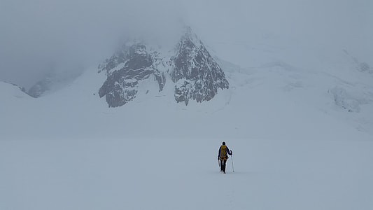 person standing on mountains covered with snow