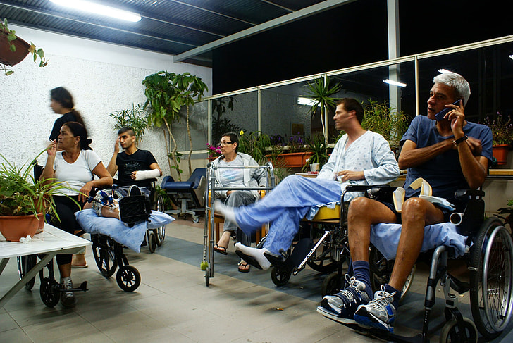 five patients sitting on wheelchairs