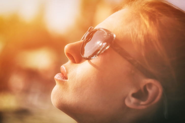 photography of woman wearing sunglasses looking towards sky