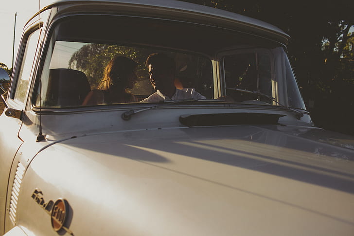 couple inside classic vehicle
