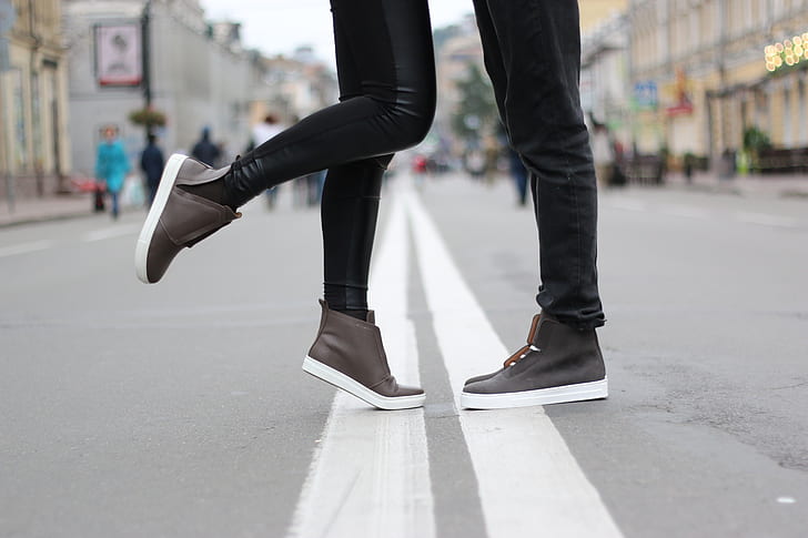 woman and man both wearing brown high top shoes