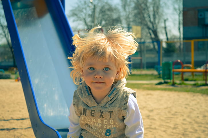 photo of child near slide