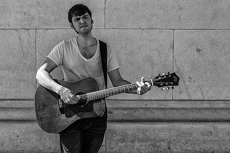 A busker plays the guitar in Greenwich Village, New York City. Image captured with a Canon 5D DSLR