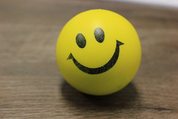 smiley ball on brown wooden surface
