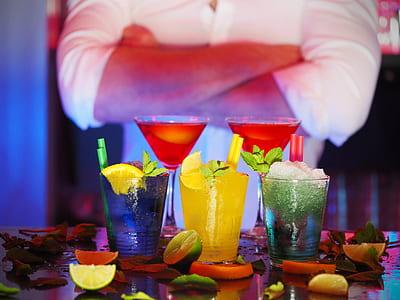 selective focus photography of five assorted-flavor drinks surrounded by lemon slices