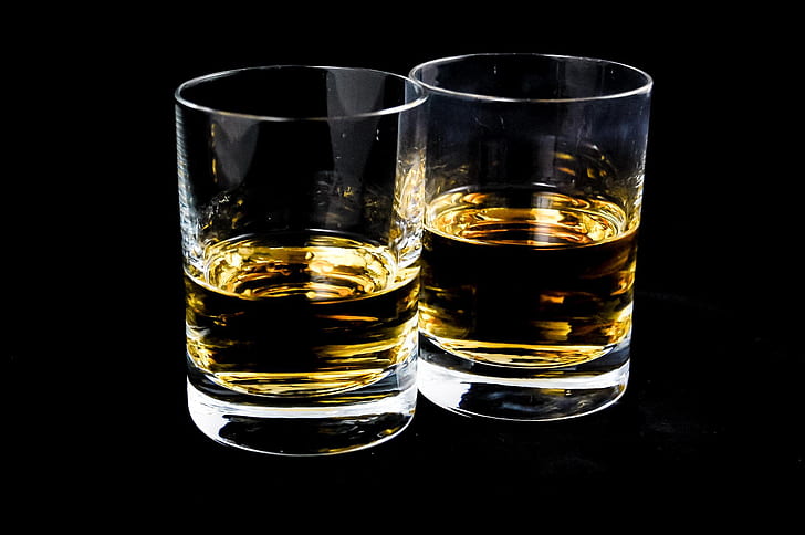 two clear glass shot glasses