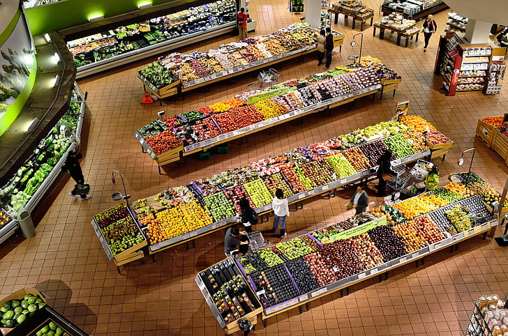 aerial view of people buying fruits display