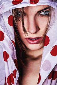 woman hiding in white polka-dot hoodie photography