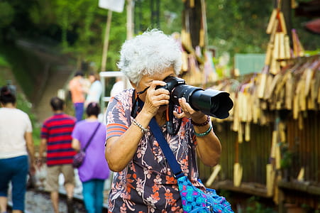 woman taking picture using DSLR camera