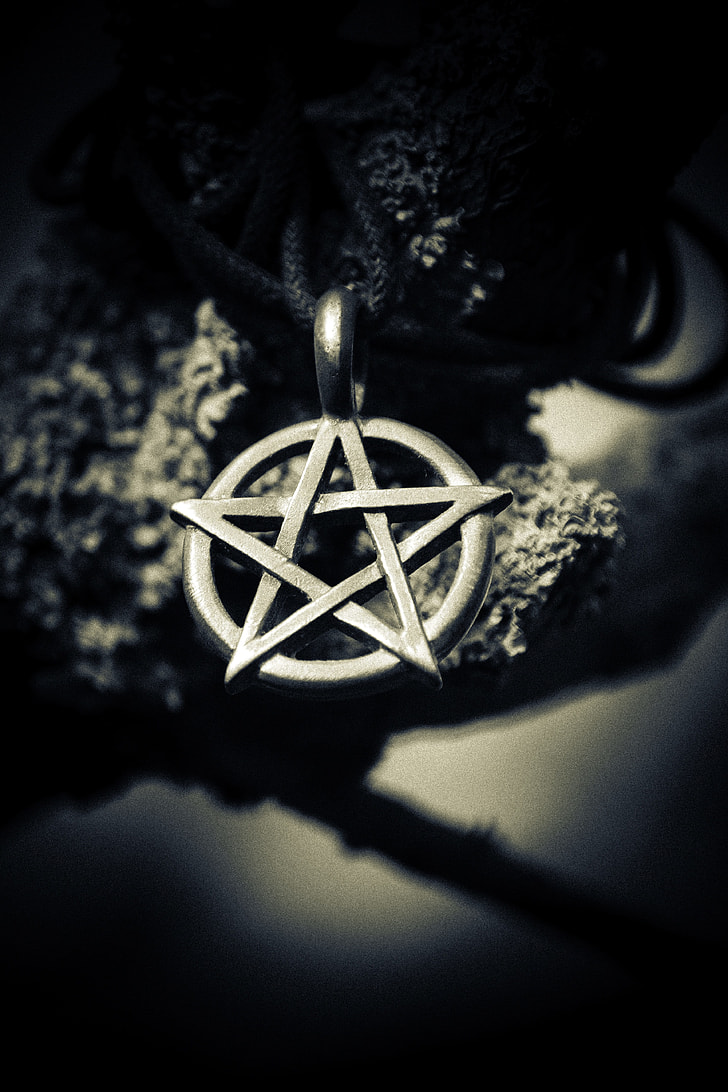 grayscale depth of field photography of star pendant