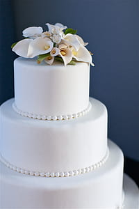 white icing coated 3-tier fondant cake photograph