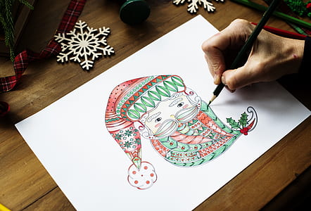 person drawing Santa Claus head