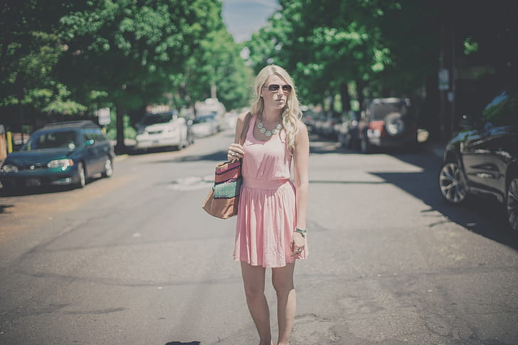woman wearing pink scoop-neck sleeveless dress at street