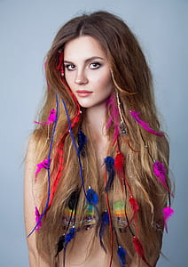 woman wearing bikini top with feather hair accessories