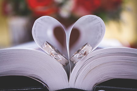 two silver-colored rings on book page