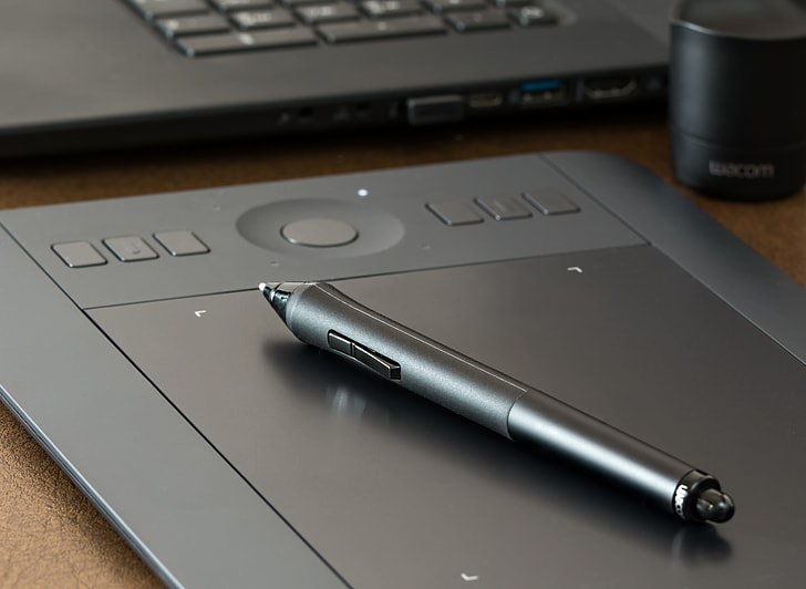 grey stylus pen on trackpad