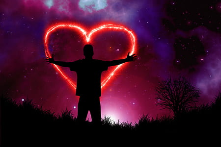 silhouette of person in the middle of a heart shape firework at night
